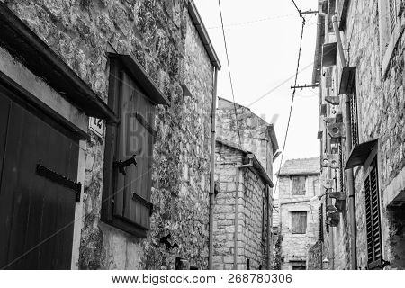 Old Adriatic Town Hvar. Medieval Street.
Popular Touristic Destination Of Croatia. Black And White P