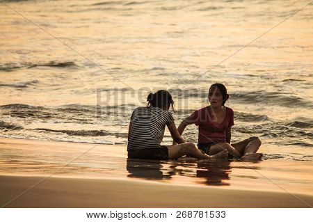 13 November 2012. Bali. Jimbaran Beach. Two Indonesian Girls Splashing On The Shore