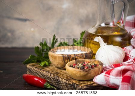 Ingredients For Cooking On Wooden Background. Spices, Herbs And Oil. Free Space For Your Text.