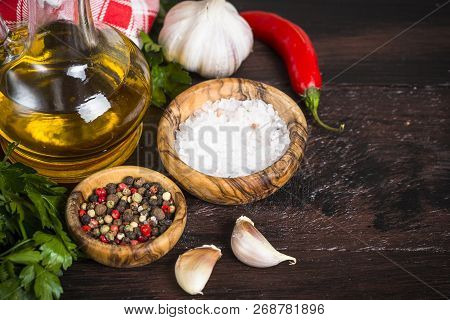 Ingredients For Cooking On Wooden Background. Spices, Herbs And Oil. Free Space For Your Text.