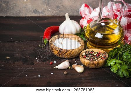 Ingredients For Cooking On Wooden Background. Spices, Herbs And Oil. Free Space For Your Text.