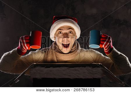 Christmas Gift Concept. Man In Santa Hat Bring Gift For You. Attractive Man Hold Box.  Christmas And