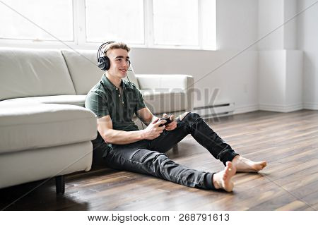 Young Attractive Man Playing Video Games In The Livingroom
