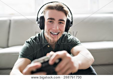 Young Attractive Man Playing Video Games In The Livingroom