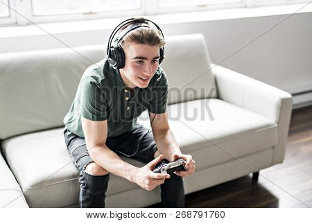 Young Attractive Man Playing Video Games In The Livingroom