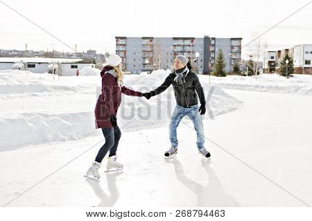 Couple In Sunny Winter Nature Ice Skating