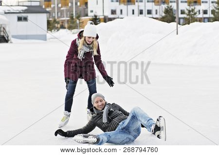 Couple In Sunny Winter Nature Ice Skating
