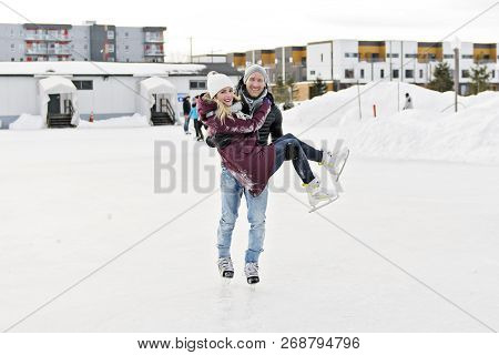 Couple In Sunny Winter Nature Ice Skating