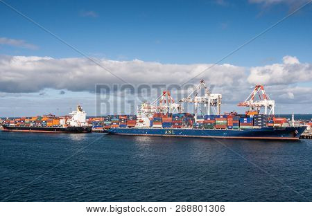 Fremantle, Australia - November 25. 2009: Two Container Ships Unload At The Sea Harbor Under Blue Sk
