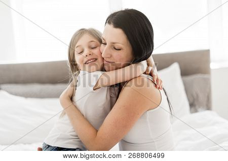 Mother And Daughter Enjoy In Bed At Home