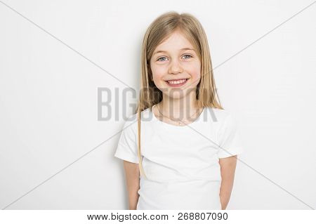Happy Small Five Years Old Girl With Straight Hair Over White Background At Home