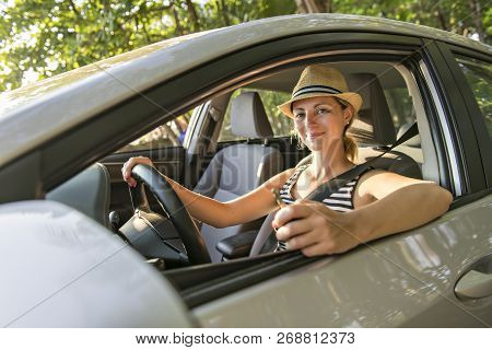 Woman Sitting In A Rental Car On Holiday Vacancy