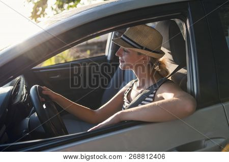 Woman Sitting In A Rental Car On Holiday Vacancy