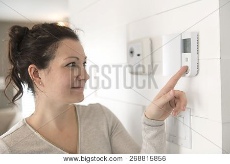 A Nice Woman Set The Thermostat At House.