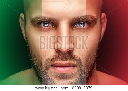 Portrait Of A Young Serious Man, In Whose Eyes The Reflected National Flag Of Italy, Against An Isol