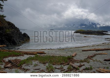 View From A Beach In Nuchatlitz Inlet With Rain Clouds Over Mountains And Sun Breaking Through, Noot