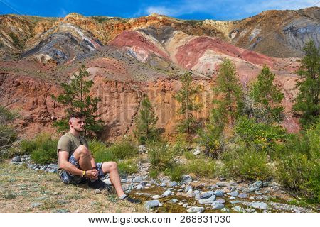 Relaxing man in Valley of Mars landscapes in the Altai Mountains, Kyzyl Chin, Siberia, Russia