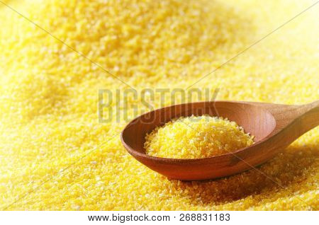 Corn Grits Yellow Background With Wooden Spoon