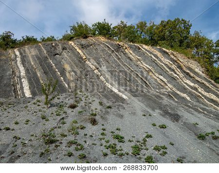 Mountain Rock With Gray, White And Brown Color Stones Vertically Arranged In Strips. Caucasus, Dzhub