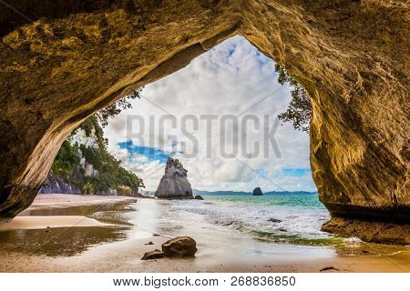 The Cathedral Cave. Coast of the North Island of New Zealand. Stunning sunset on the beach. Concept of active and ecological tourism