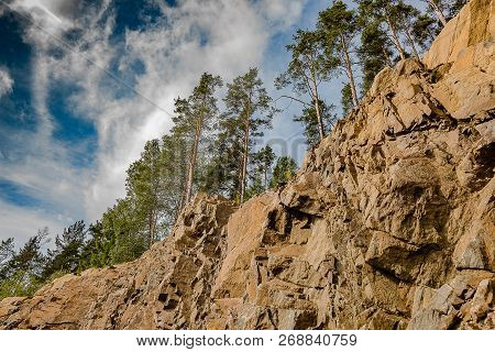The Landscape Of Marble Canyon In Karelia. Mountains And Rocks Of Marble Canyon. Pines On The Edge O