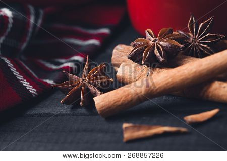 Anise Star Spices And Cinnamon Sticks On Dark Rystic Wooden Background