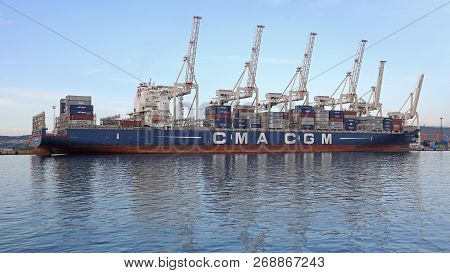 Koper, Slovenia - October 14, 2014: Pier Side Gantry Cranes Tower Over Big Container Ship In Koper, 