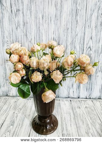 Bouquet Of Cream Peony Roses In A Vase On A Wooden Background. Work In A Flower Shop
