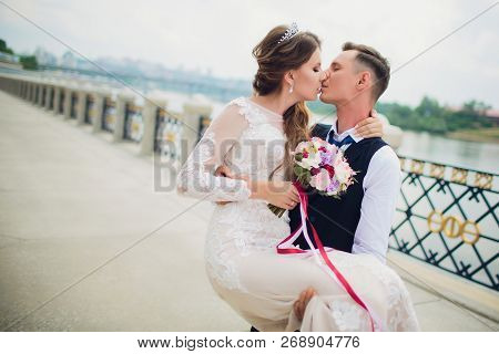 Stylish Bride And Groom Posing On The Background Of The River.