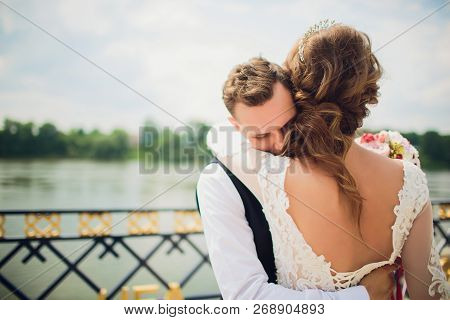 Stylish Bride And Groom Posing On The Background Of The River.