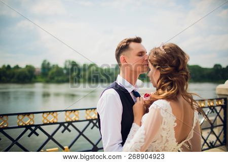 Stylish Bride And Groom Posing On The Background Of The River.