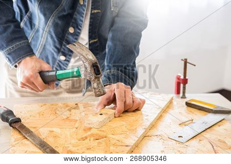 Carpenter Working Carefully Looking At The Plans Work In Carpentry. He Is Successful Entrepreneur At