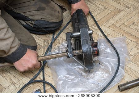 Plumber Squeezes The Metal Tube Of The Press With Ticks. Close-up.