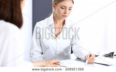 Group Of Business People Or Lawyers Discussing  Terms Of Transaction In Office. Colleagues Working A