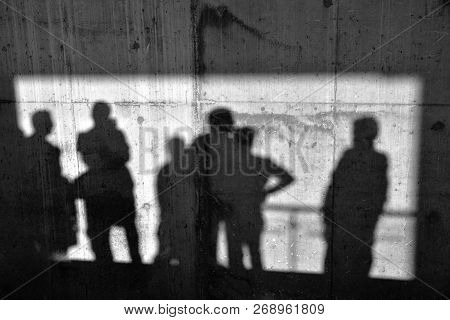 Shadows Of People On The Concrete Wall
