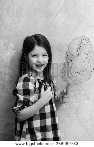 Happy, Adorable Girl, Small, Little, Child In Plaid Dress Smiling With Delicious, Pink, Cotton Candy