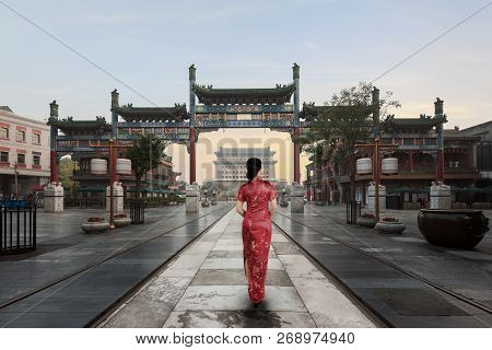 Asian Young Woman In Old Traditional Chinese Dresses In Hutong Village In Beijing, China.