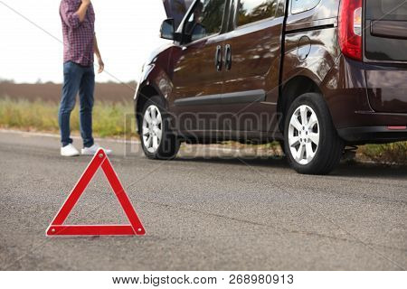 Emergency Stop Sign And Driver Near Broken Car On Road. Auto Insurance