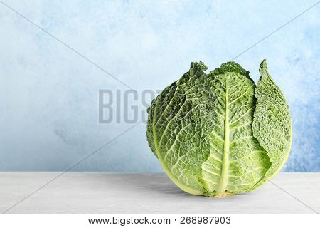 Savoy Cabbage On Table Against Color Background. Space For Text