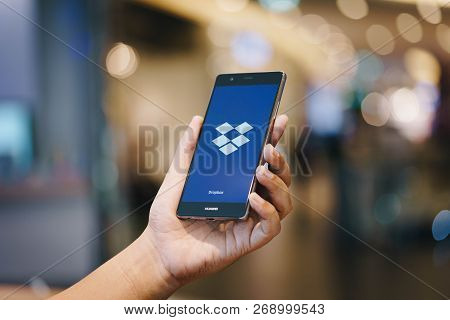Chiang Mai, Thailand - Oct. 28,2018: Man Holding Huawei With Dropbox On Screen. Dropbox Is A Service
