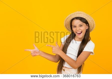 I Like Summer. Happy Child Pointing At Yellow Background. Little Girl With Pointing Gesture. Index F