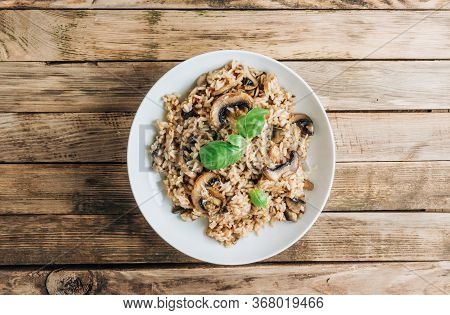 Homemade Traditional Italian Mushroom Risotto On Rustic Wooden Background. Classic Risotto With Mush