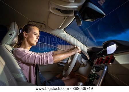 Young female driver at the wheel of her car - Road safety concept