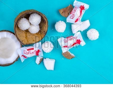 Chelyabinsk, Russia - May 22, 2019: Candies Rafaello In Coconut Flakes And Coconut On Blue Backgroun