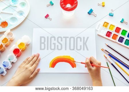 Girl Painting Rainbow On Paper During Covid-19 Quarantine At Home.
