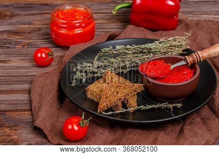 Ajvar Or Pindjur Red Vegetable Spread Or Pepper Paprika And Tomato Mousse In A Clay Bowl In A Black 