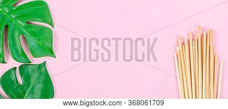 Wheat Straw For Drinking Water And Green Leaves With Empty Space For Your Text Or Message On Pink Ba