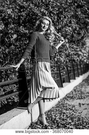 Cute Smiling Woman. Sunny Day With Leaves. Fall Fashion Season. Girl In Corrugated Skirt And Sweater