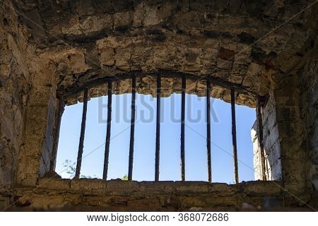 Texture Of Old Ancient Brick Wall, Iron Grille Instead Of A Window, Old Prison