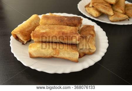 Famous Traditional Middle East, Asian Cuisine. Vegetable Spring Rolls And Mini Samosa On Dark Wooden